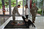 CRDAMC facility dog, 1st Lt. Solomon greets Col. Mark Jacques, Carl R. Darnall Army Medical Center commander, with one of his signature “bops” during his promotion ceremony June 11 at Fort Hood, Texas. Solomon was promoted to first lieutenant after a year of providing comfort and support to patients, families, and staff across the medical center.