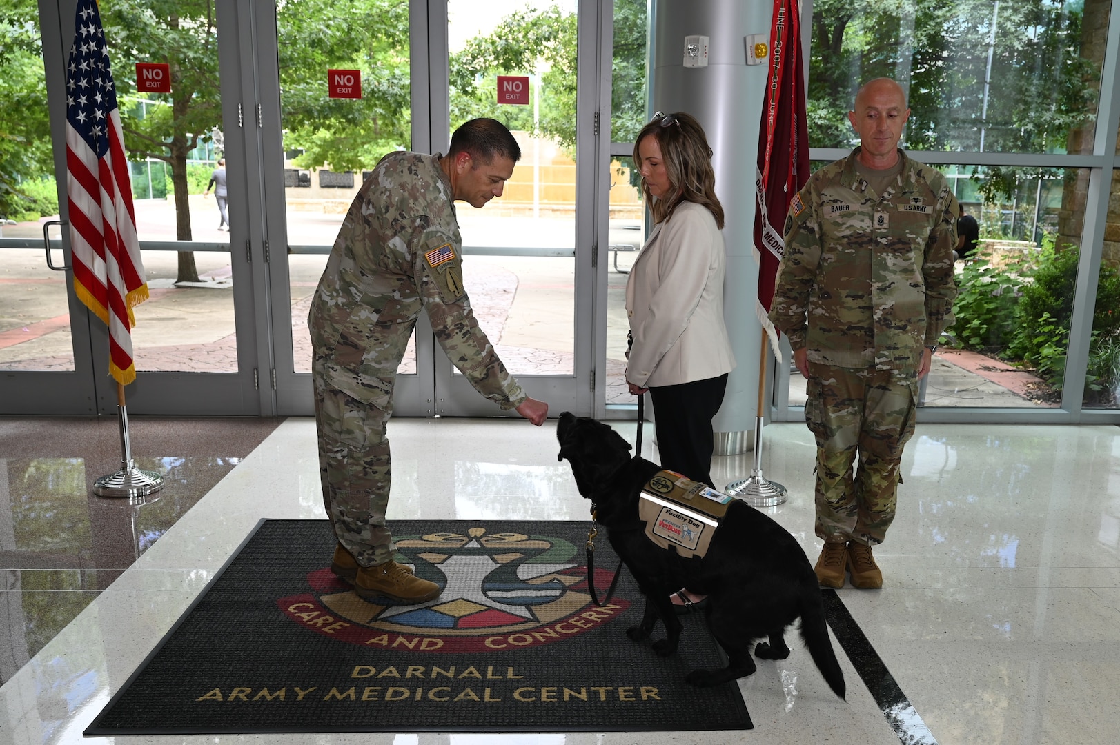 CRDAMC facility dog, 1st Lt. Solomon greets Col. Mark Jacques, Carl R. Darnall Army Medical Center commander, with one of his signature “bops” during his promotion ceremony June 11 at Fort Hood, Texas. Solomon was promoted to first lieutenant after a year of providing comfort and support to patients, families, and staff across the medical center.