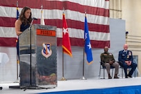 The daughter of Maj. Gen. Daniel R. McDonough speaks from a podium during a retirement ceremony at the 182nd Airlift Wing in Peoria, Illinois, June 6, 2026.