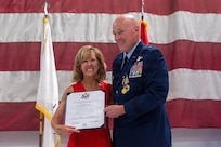 U.S. Air Force Maj. Gen. Daniel R. McDonough presents his wife, Cindy McDonough, with a Certificate of Recognition during his retirement ceremony at the 182nd Airlift Wing in Peoria, Illinois, June 6, 2026.