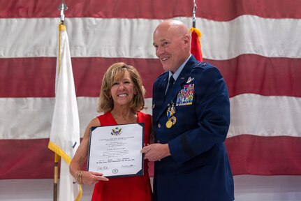 U.S. Air Force Maj. Gen. Daniel R. McDonough presents his wife, Cindy McDonough, with a Certificate of Recognition during his retirement ceremony at the 182nd Airlift Wing in Peoria, Illinois, June 6, 2026.