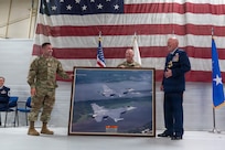 U.S. Air Force Col. Robert Reed, center, presents a framed photograph of F-16 Fighting Falcon aircraft to Maj. Gen. Daniel R. McDonough during a retirement ceremony at the 182nd Airlift Wing in Peoria, Illinois, June 6, 2026.