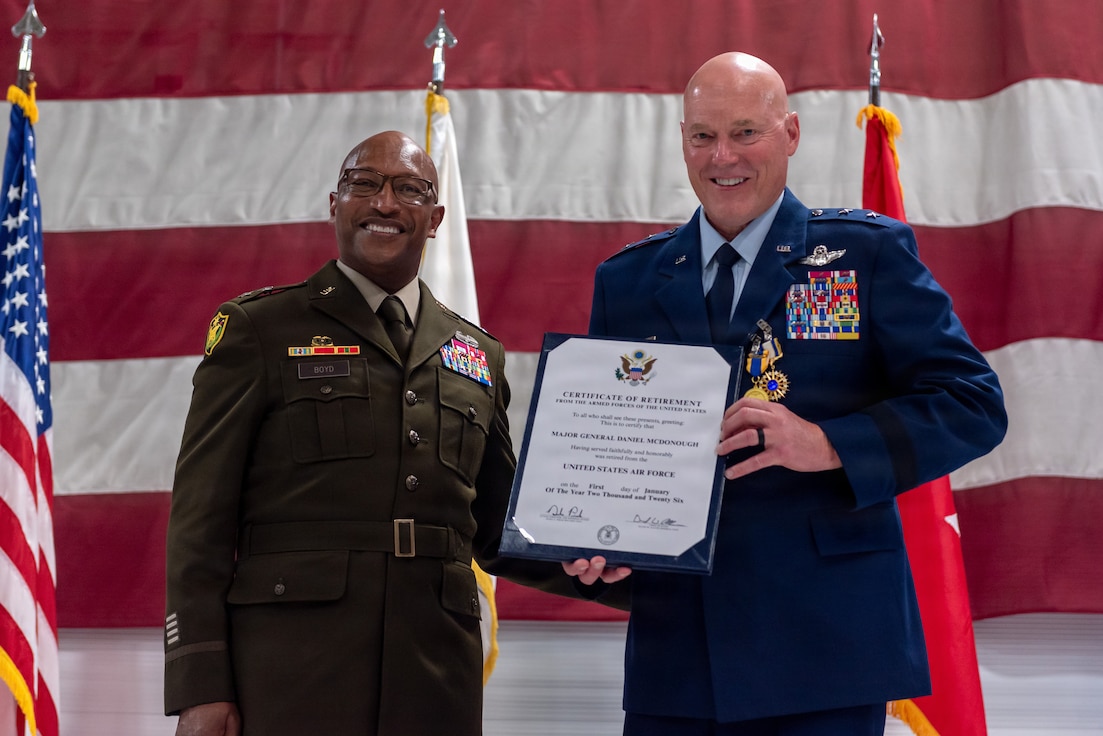 U.S. Army Maj. Gen. Rodney Boyd, left, and U.S. Air Force Maj. Gen. Daniel R. McDonough hold a Certificate of Retirement during a ceremony at the 182nd Airlift Wing in Peoria, Illinois, June 6, 2026.