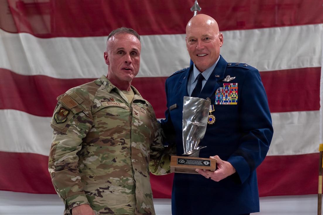 U.S. Air Force Col. Shawn Strahle, left, presents a mounted jet engine fan blade to Maj. Gen. Daniel R. McDonough during a retirement ceremony at the 182nd Airlift Wing in Peoria, Illinois, June 6, 2026.