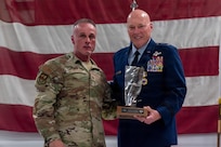 U.S. Air Force Col. Shawn Strahle, left, presents a mounted jet engine fan blade to Maj. Gen. Daniel R. McDonough during a retirement ceremony at the 182nd Airlift Wing in Peoria, Illinois, June 6, 2026.