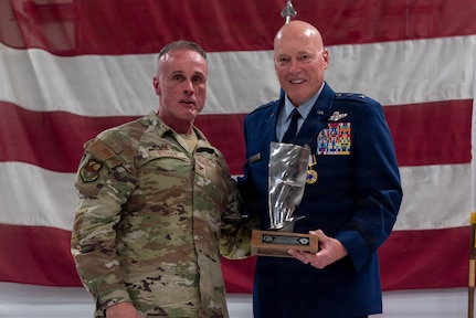 U.S. Air Force Col. Shawn Strahle, left, presents a mounted jet engine fan blade to Maj. Gen. Daniel R. McDonough during a retirement ceremony at the 182nd Airlift Wing in Peoria, Illinois, June 6, 2026.
