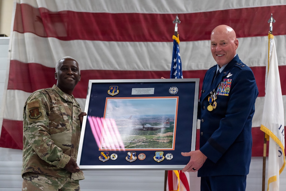 U.S. Air Force Brig. Gen. Kevin Jacobs, left, presents a framed aerial photograph to Maj. Gen. Daniel R. McDonough during a retirement ceremony at the 182nd Airlift Wing in Peoria, Illinois.