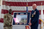 U.S. Air Force Brig. Gen. Kevin Jacobs, left, presents a framed aerial photograph to Maj. Gen. Daniel R. McDonough during a retirement ceremony at the 182nd Airlift Wing in Peoria, Illinois.
