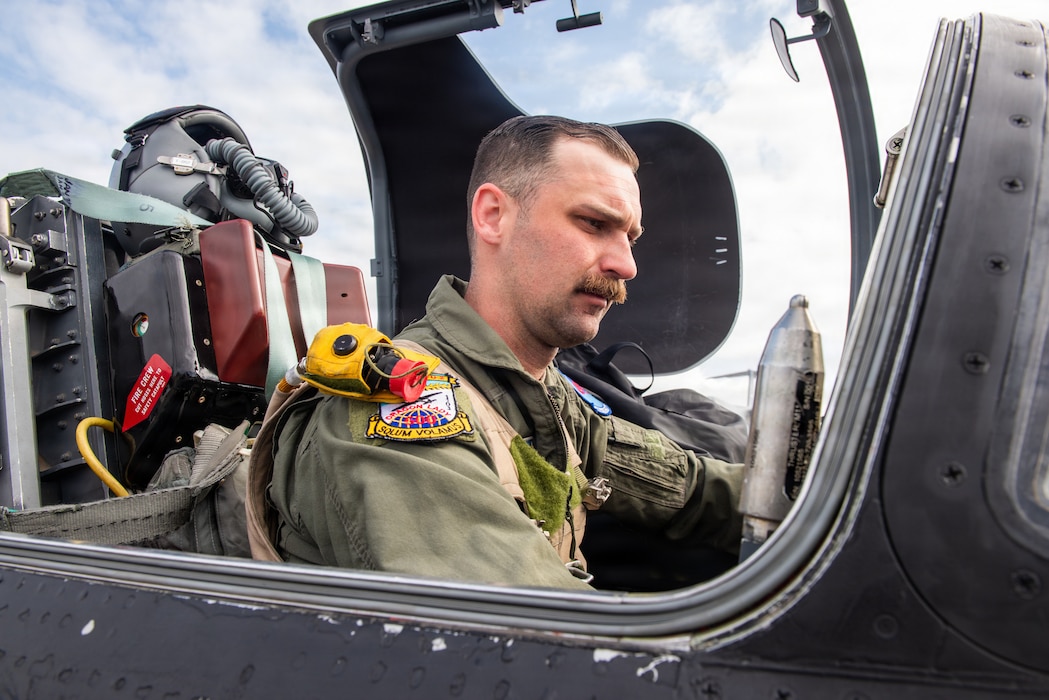 Pilot conducts pre-flight check in aircraft cockpit