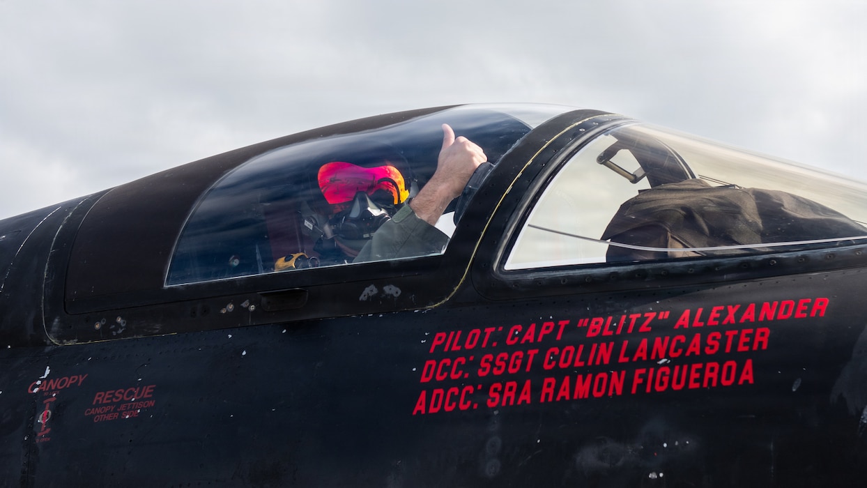 Pilot gives a thumbs up from cockpit of aircraft