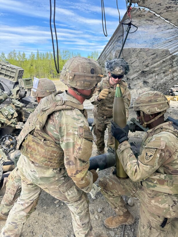 Soldiers assigned to 2nd Battalion, 377th Parachute Field Artillery Regiment, 2nd Brigade Combat Team, 11th Airborne Division handle a 105mm round during an Artillery Table VI live fire qualification at Richardson Training Area, Alaska, June 2, 2026.