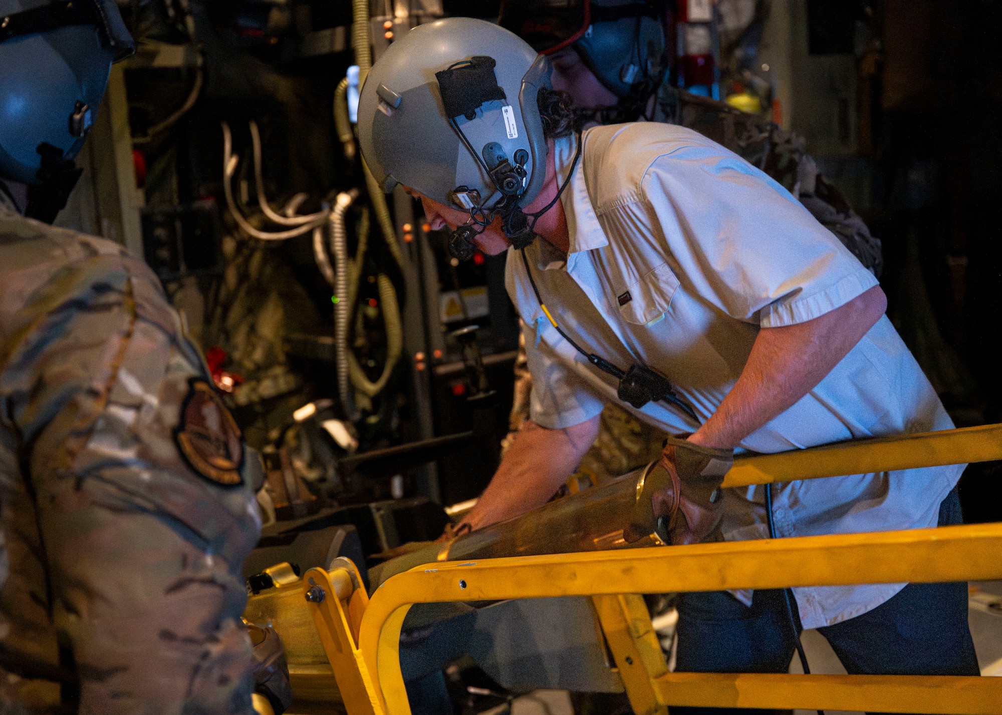 Rep. Ronny Jackson, Chairman of House Armed Services Subcommittee on Intelligence and Special Operations, loads a 105 mm round aboard an AC-130J Ghostrider