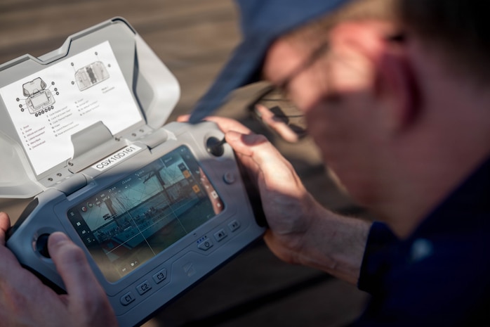 A photo of a man piloting a drone.
