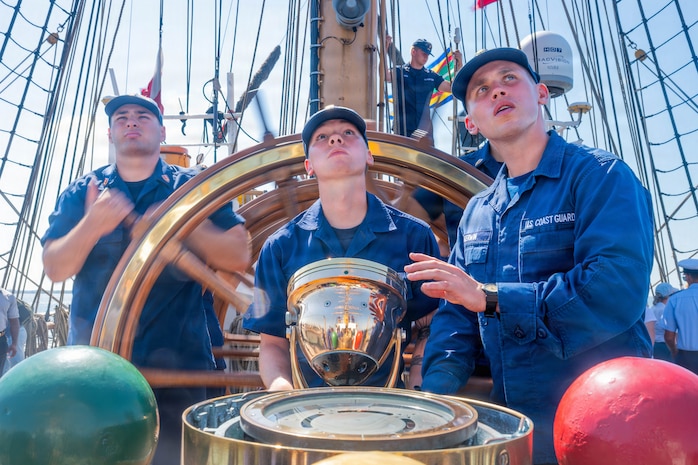 A photo of Coast Guardsmen steering the Coast Guard Cutter Eagle.