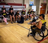 Team Army competitors listen as retired Army Staff Sgt. Joel Rodriguez, Team Army wheelchair rugby coach, speaks to the team before practice during the Army Team Sports Camp in San Antonio, Texas, May 5, 2026.
