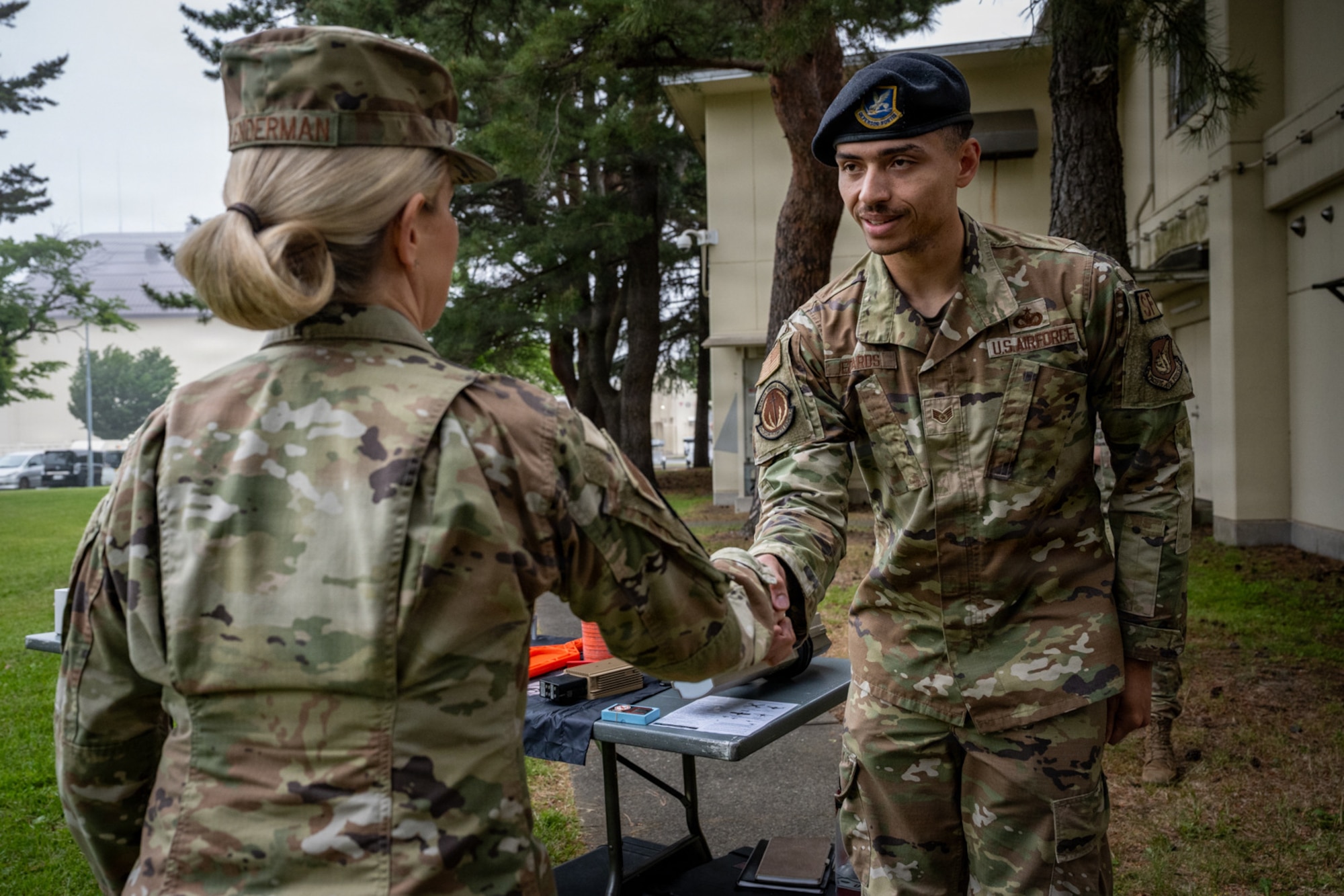 U.S. Air Force Lt. Gen. Laura Lenderman, Pacific Air Forces deputy commander, awards a recognition coin to Staff Sgt. Deante Edward, 35th Security Forces Squadron counter-small unmanned aircraft systems noncommissioned officer in charge.