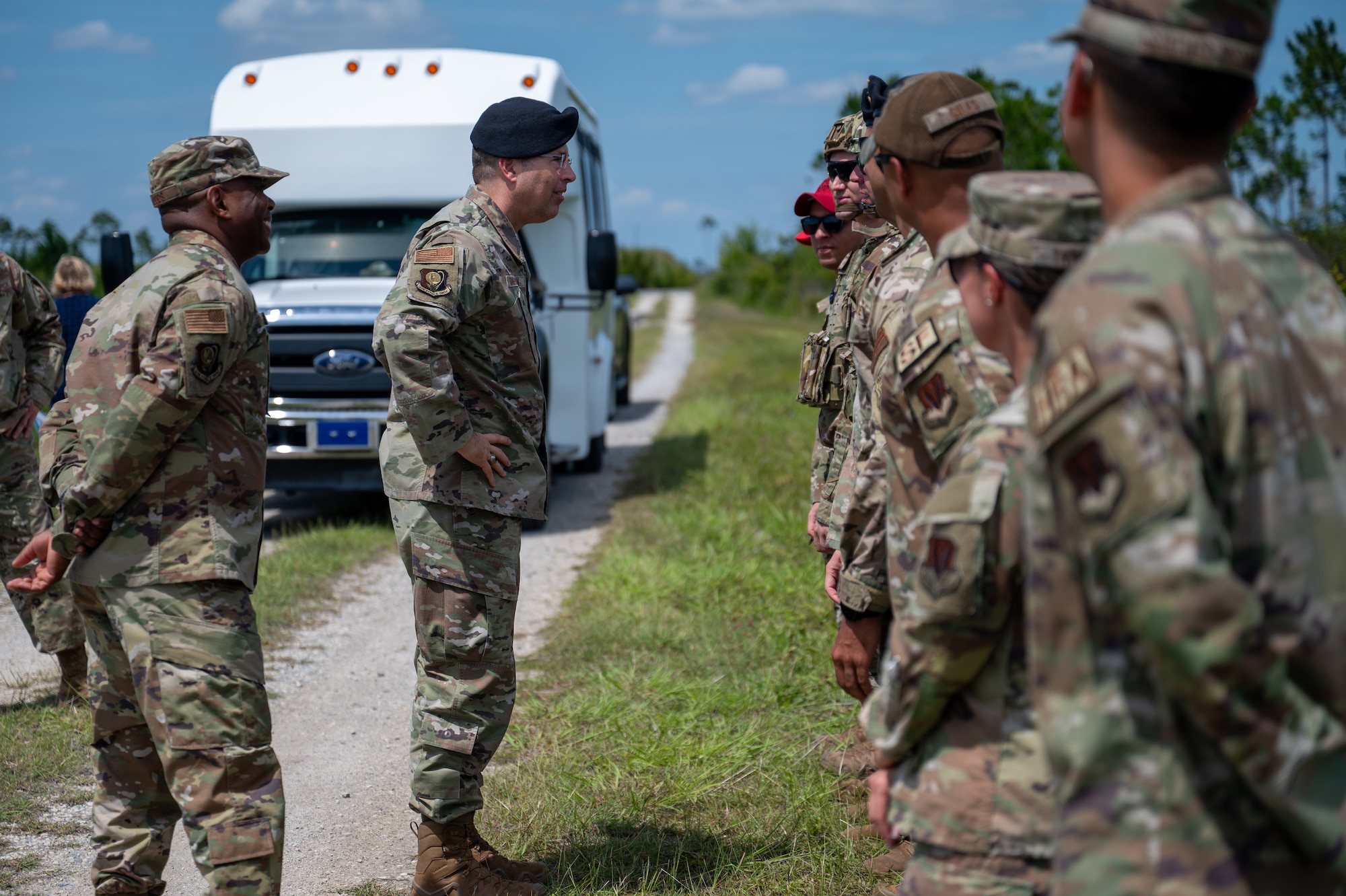 U.S. Air Force Maj. Gen. Thomas P. Sherman, commander of the Air Force Installation and Mission Support Center, and Chief Master Sgt. Ronnie J. Woods, AFIMSC command chief, greet Airmen assigned to the 325th Security Forces Squadron at Tyndall Air Force Base, Florida, June 3, 2026. The visit allowed AFIMSC leadership to observe the squadron's readiness efforts firsthand, including a live-fire demonstration of new counter-drone tactics. (U.S. Air Force photo by Airman 1st Class Rosario Garcia)