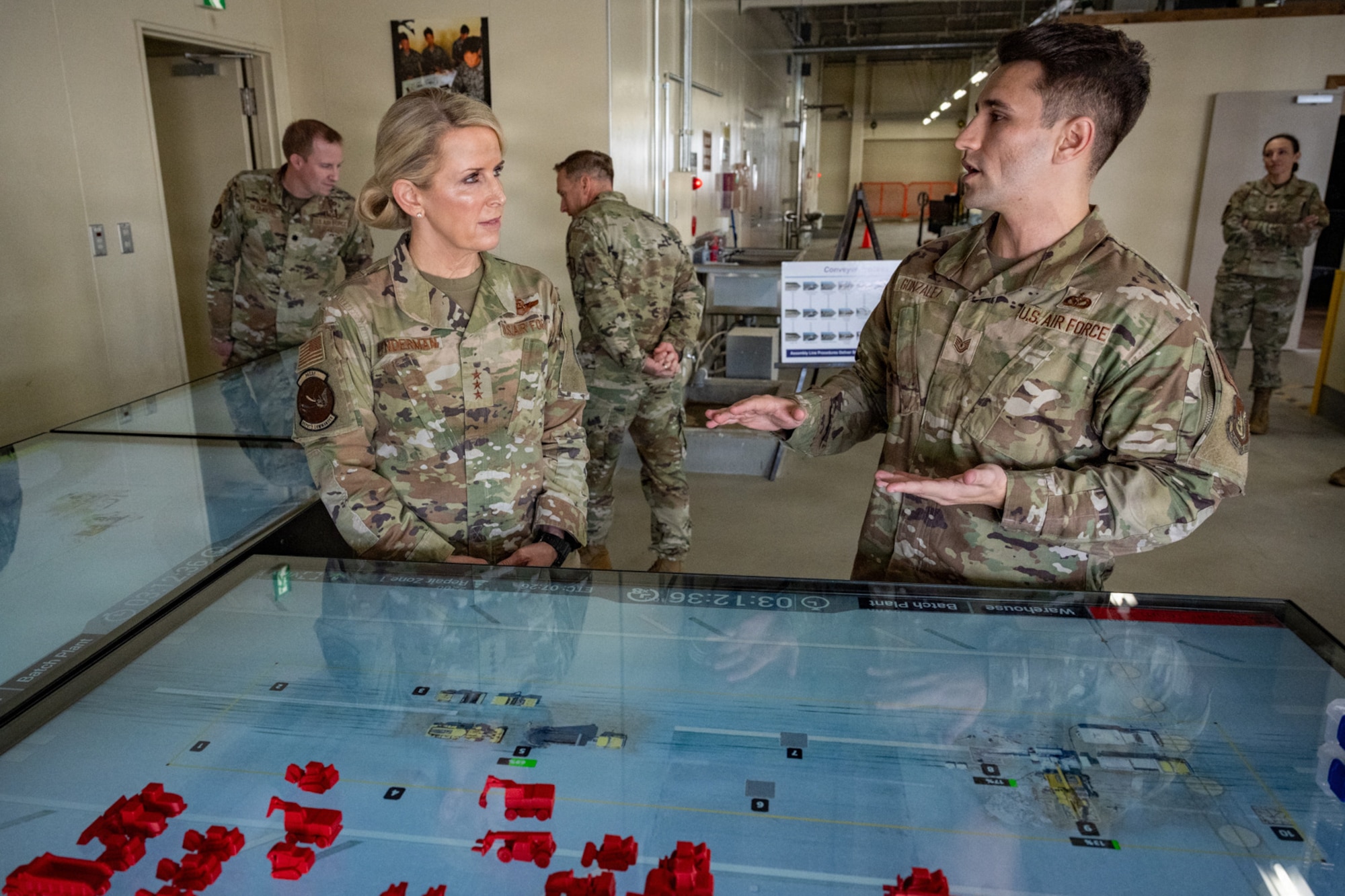 U.S. Air Force Senior Airman Colin Seaver, 35th Civil Engineer Squadron pavements and equipment journeyman, right, shows a virtual Rapid Airfield Damage Repair training table to Lt. Gen. Laura Lenderman, Pacific Air Forces deputy commander, during her visit.