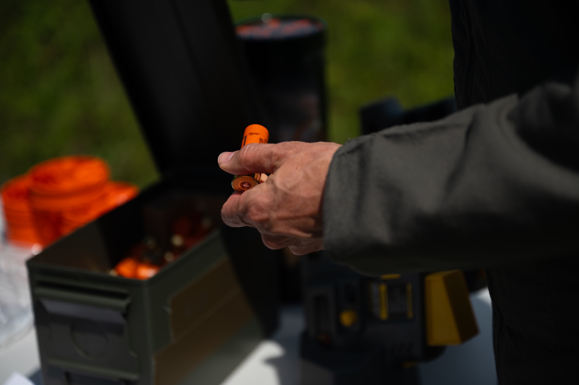 U.S. Air Force Col. Christian Bergtholdt, 325th Fighter Wing commander, handles 12-gauge shotgun ammunition during a live-fire demonstration of counter-small unmanned aircraft systems capabilities at Tyndall Air Force Base, Florida, June 3, 2026. The demonstration highlighted the 325th Security Forces Squadron's plan to train defenders in kinetic base defense. (U.S. Air Force photo by Airman 1st Class Rosario Garcia)