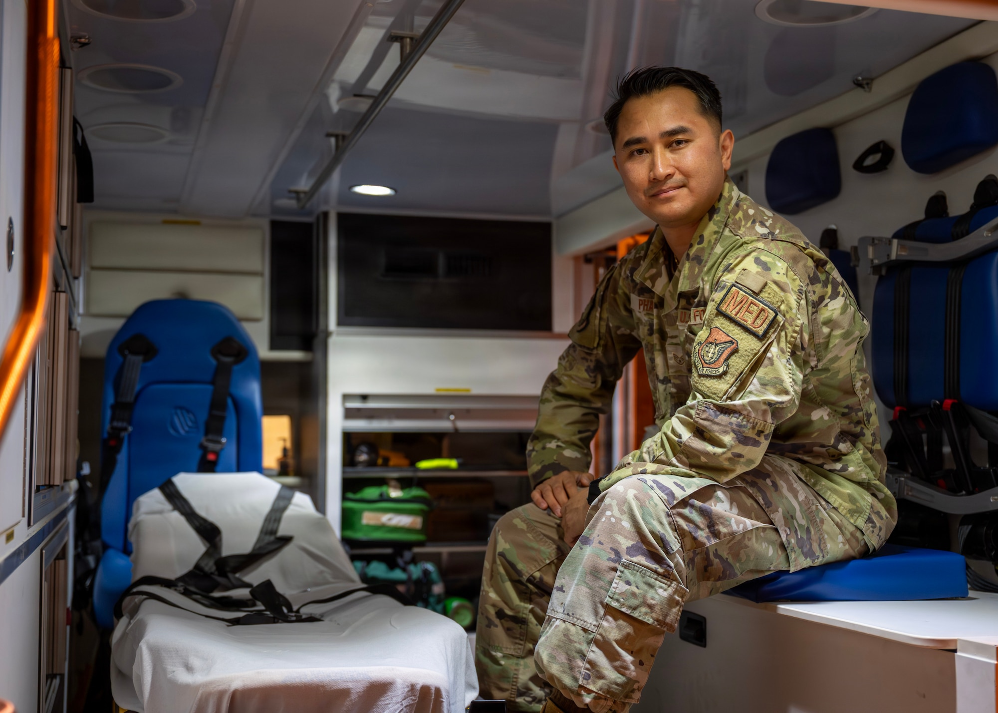 U.S. Air Force Staff Sgt. Tin Phan, 51st Operational Medical Readiness Squadron base operational medicine clinic noncommissioned officer in charge, poses for a photo in an ambulance at Osan Air Base, Republic of Korea, June 10, 2026. Phan was recognized as Mustang of the Week for his commitment to service, supporting Airmen and strengthening mission readiness. (U.S. Air Force photo by Staff Sgt. Sarah Williams)