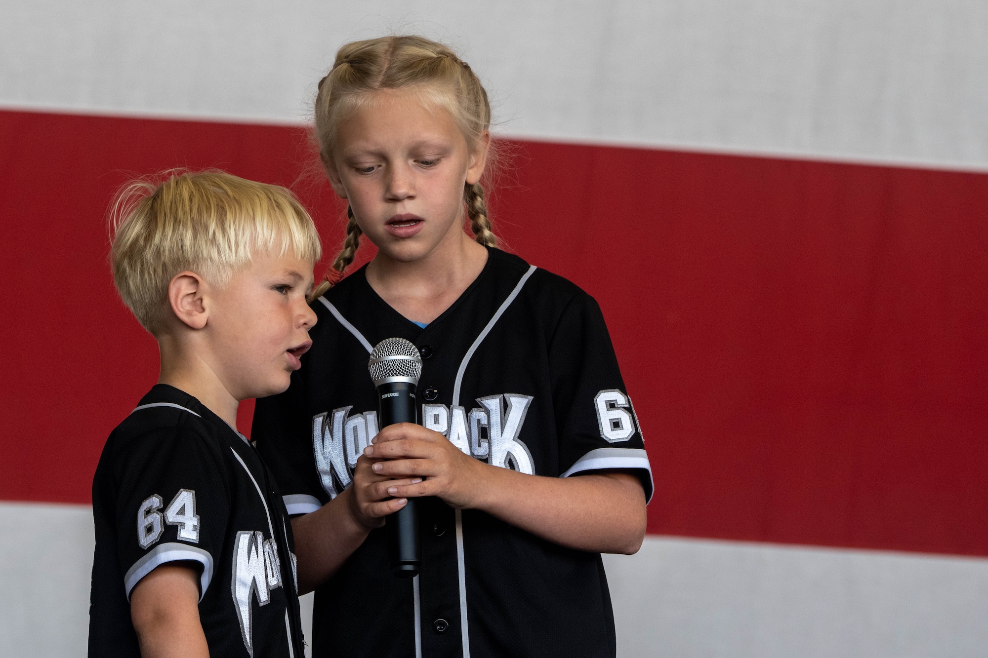 Children sing.