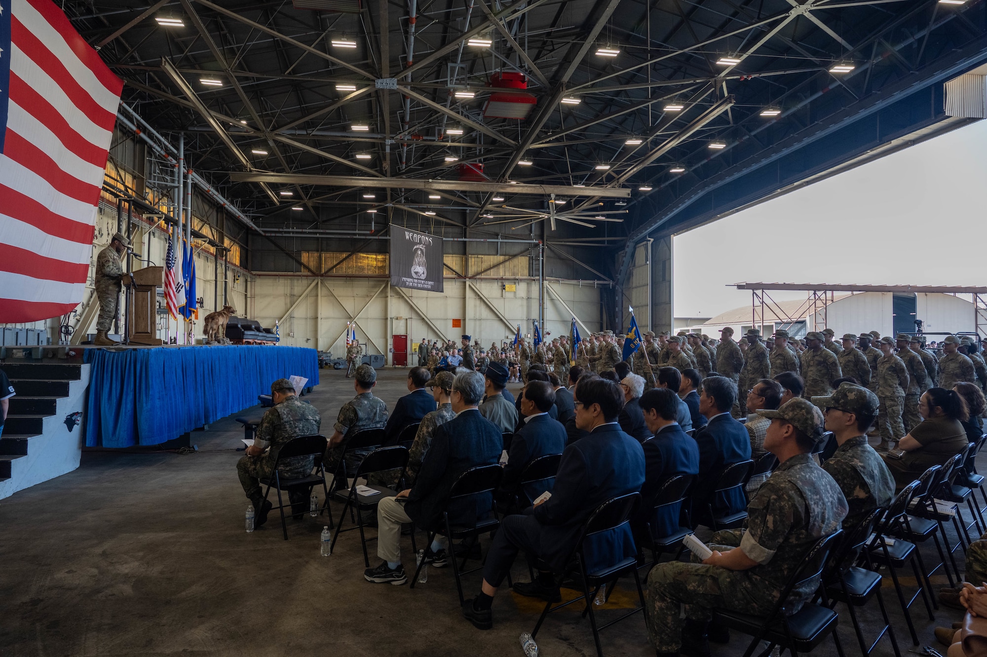 A crowd attends the change of command ceremony.