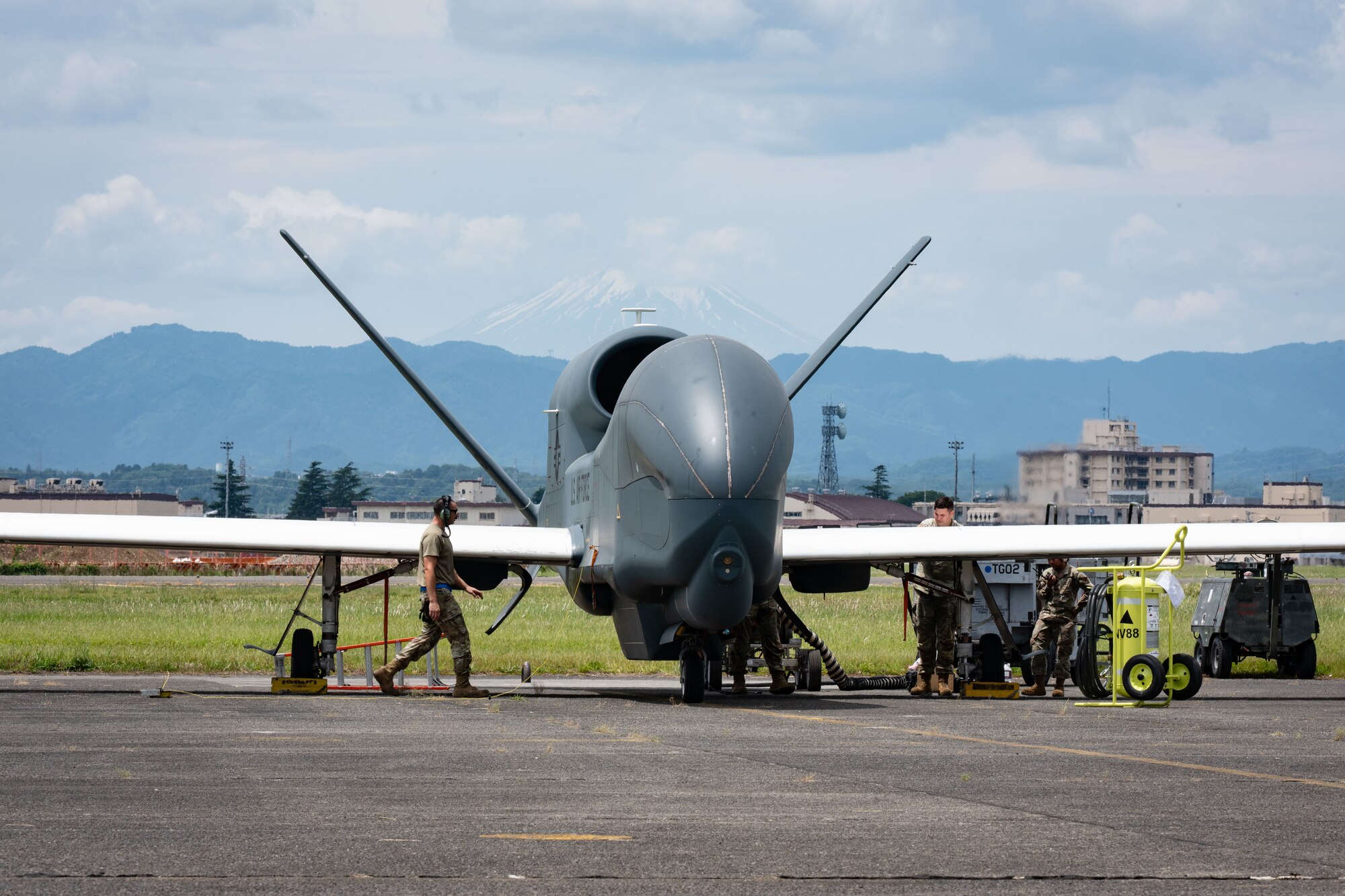 A military drone stands static on a flightline