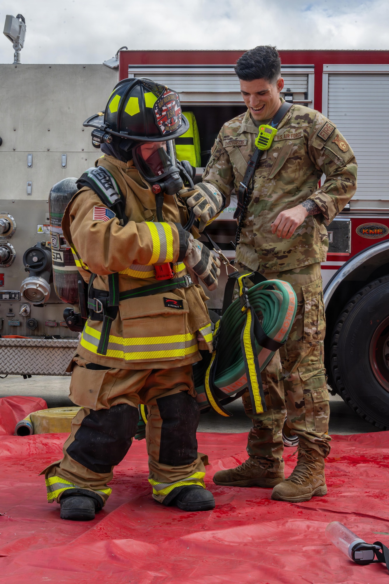 A U.S. Air Force Airman assists a competitor with putting on fire protection gear during Joan Mann Special Sports Day at RAF Mildenhall, England, June 4, 2026.