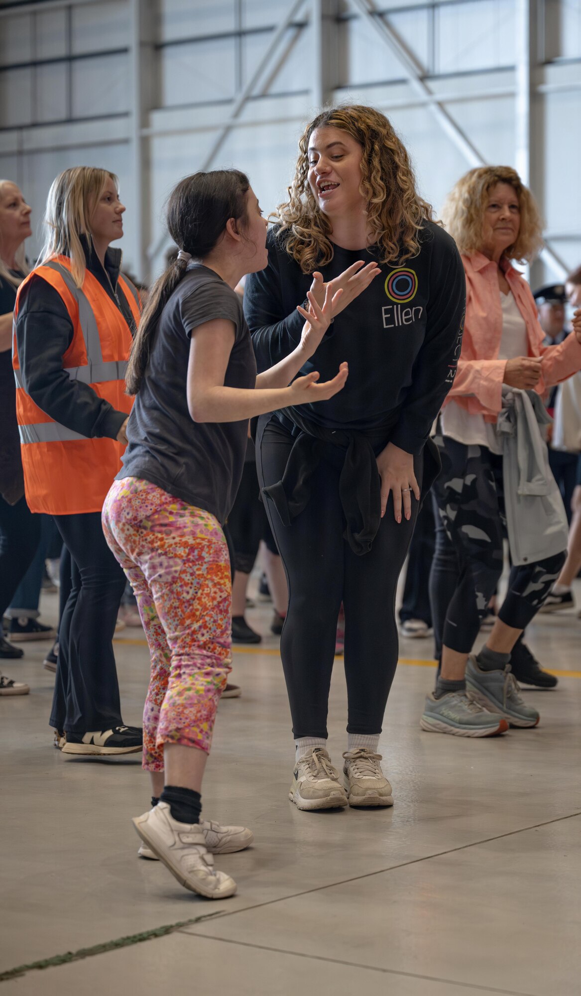 An athlete and her escort dance and sing during the Zumba portion of Joan Mann Special Sports Day at RAF Mildenhall, England, June 4, 2026.
