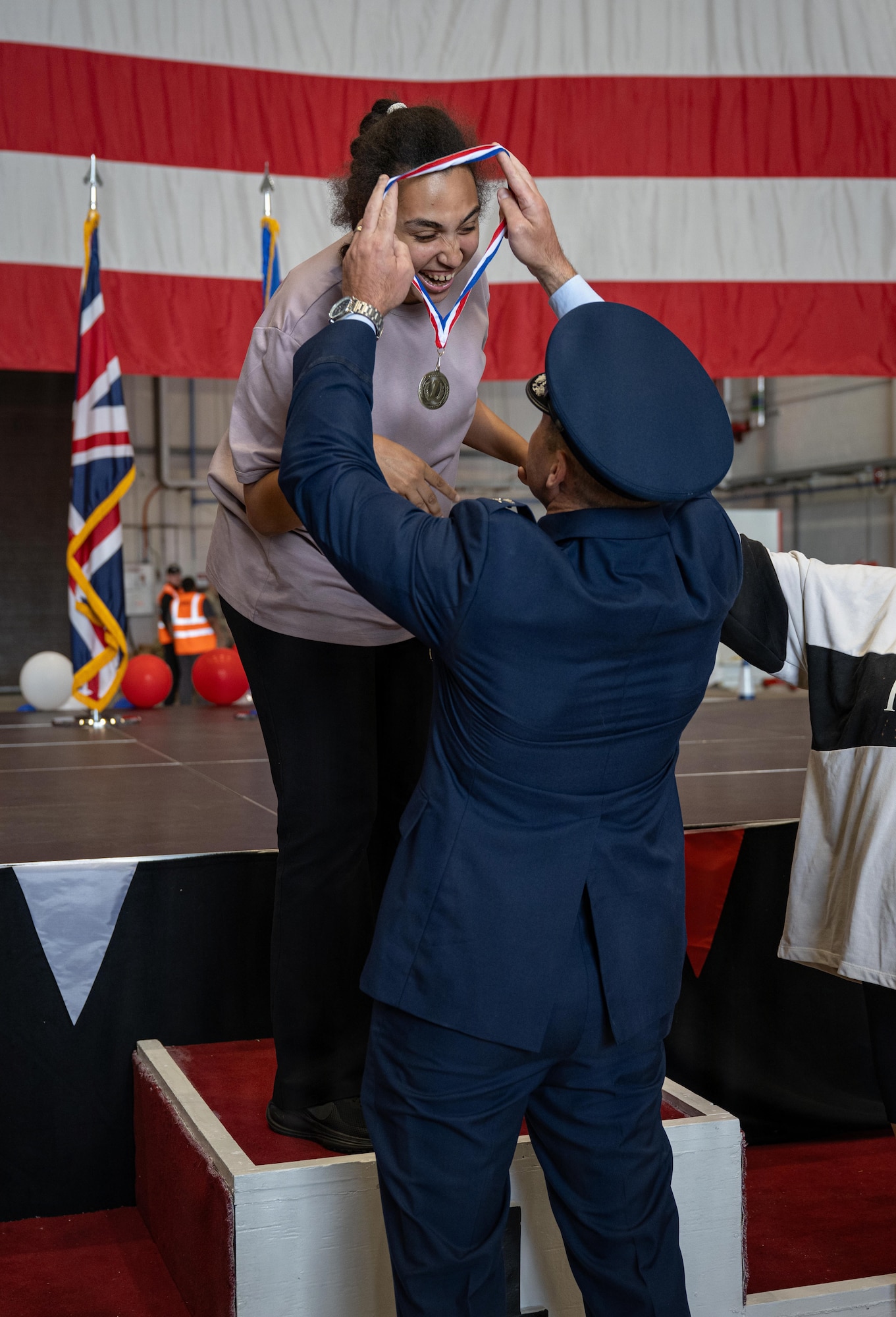 U.S. Air Force Col. Scott Korell, 100th Operations Group commander, bestows a medal upon a winning athlete during Joan Mann Special Sports Day at RAF Mildenhall, England, June 4, 2026.