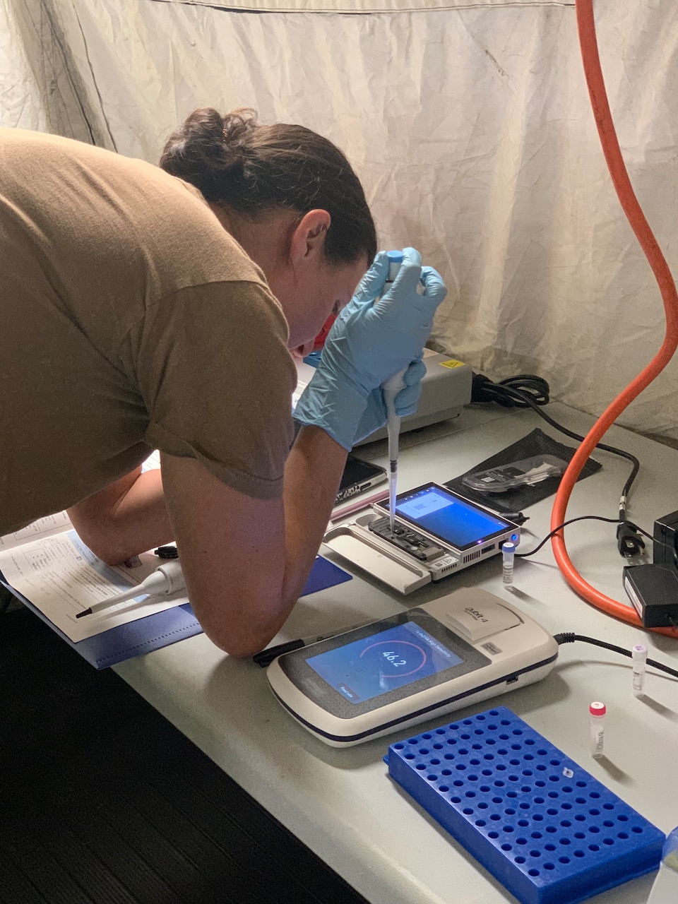 An end user loads a flow cell on a modified field sequencing device during Beholder’s Gaze training, Oct. 24, 2024. The event was attended by the U.S. Naval Research Laboratory and U.S. Army Combat Capabilities Development Command (DEVCOM) Chemical Biological Center military operators Far-Forward Advanced Sequencing Technology (F-FAST) team who conducted training and provided the technology/system. The effort brings sophisticated laboratory capability into austere environments, giving forward-deployed units the ability to detect and identify harmful pathogens in less than 30 minutes. Unlike conventional sequencing systems, Far-Forward Biological Sequencing (FFBS) is tailored for military personnel who may not have formal laboratory training. (U.S. Navy photo)