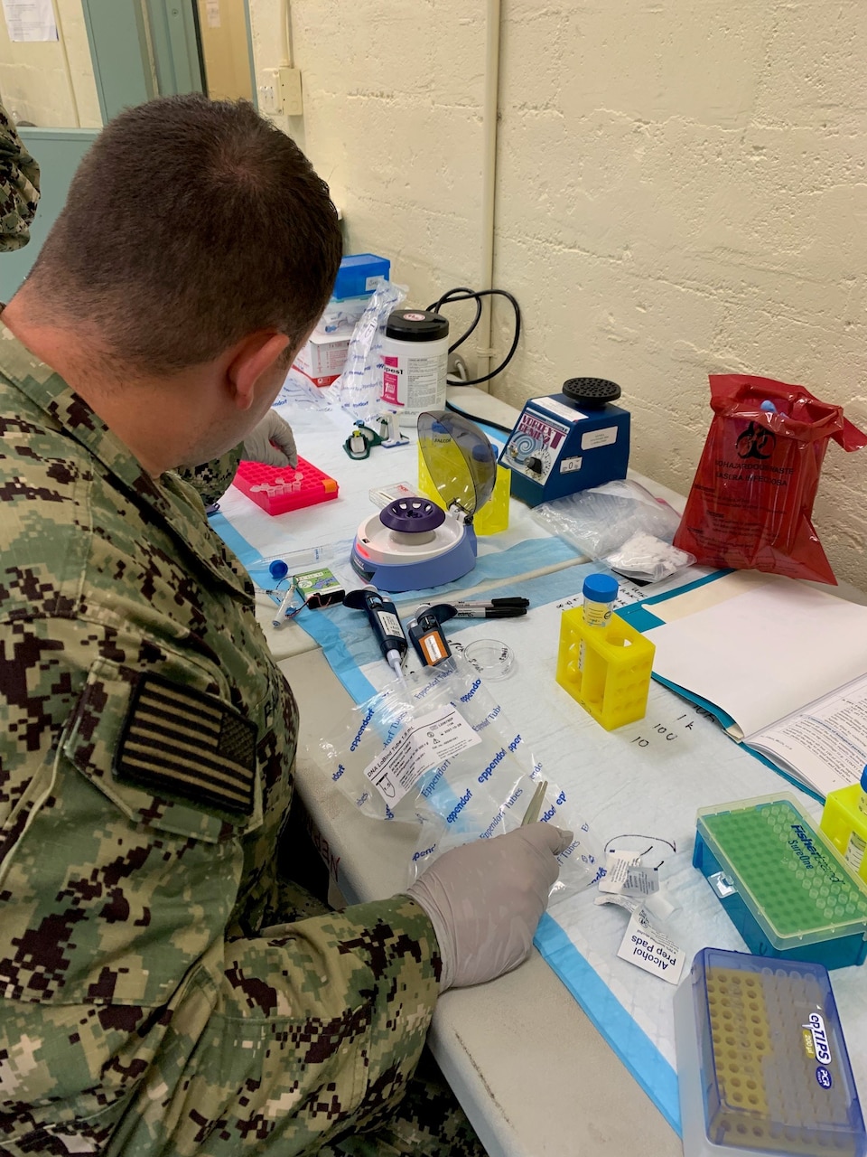A Forward Deployable Preventive Medicine Unit (FDPMU) operator prepares sample for sequencing during a scenario at Beholders Gaze held at Marine Corps Training Area Bellows, Oahu, Hawaii, Oct. 28, 2024. Image shows a laboratory trained Navy corpsman using methods initially developed under Far-Forward Advanced Sequencing Technology (F-FAST) for a mobile laboratory environment to prepare an air filter sample. The effort brings sophisticated laboratory capability into austere environments, giving forward-deployed units the ability to detect and identify harmful pathogens in less than 30 minutes. (U.S. Navy photo)