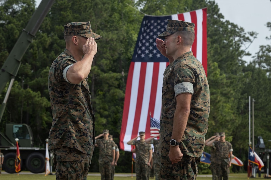 U.S. Marine Corps Lt. Col. Chad Phillips, right, the outgoing commanding officer of Headquarters and Service Battalion, 2nd Marine Logistics Group, and Lt. Col. Dustin Scott, the incoming commanding officer of Headquarters and Service Battalion, 2nd MLG, salute during a change of command ceremony at Marine Corps Base Camp Lejeune, North Carolina, June 10, 2026. The change of command ceremony is a time-honored tradition which formally signifies the transfer of command and entails the total accountability, authority and responsibility from one individual to another. Phillips is a native of Minnesota. Scott is a native of Florida. (U.S. Marine Corps photo by Lance Cpl. Isabelle Veillette)