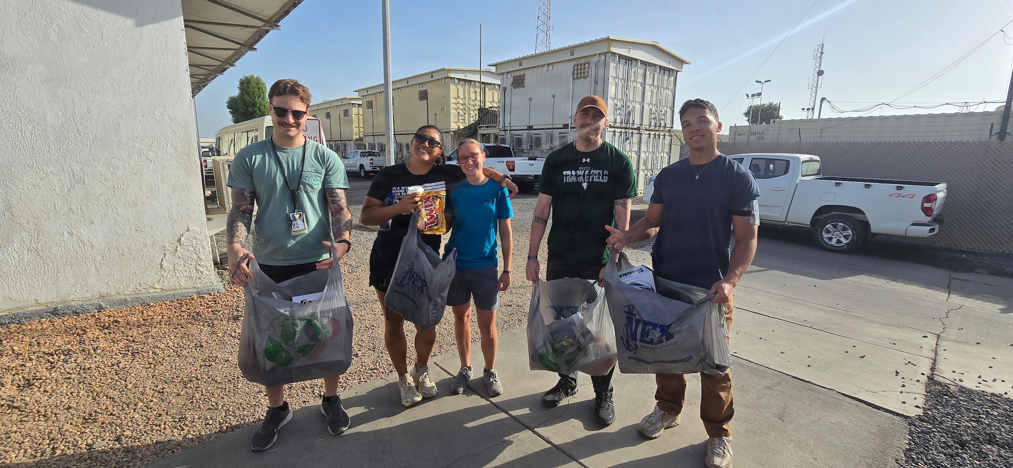 Air National Guardsmen take a photo with locals while volunteering at a orphanage during their deployment in Djibouti, Feb. 21. Members of the 130th Airlift Wing set up a medical clinic to assist with wound care for the local populace.