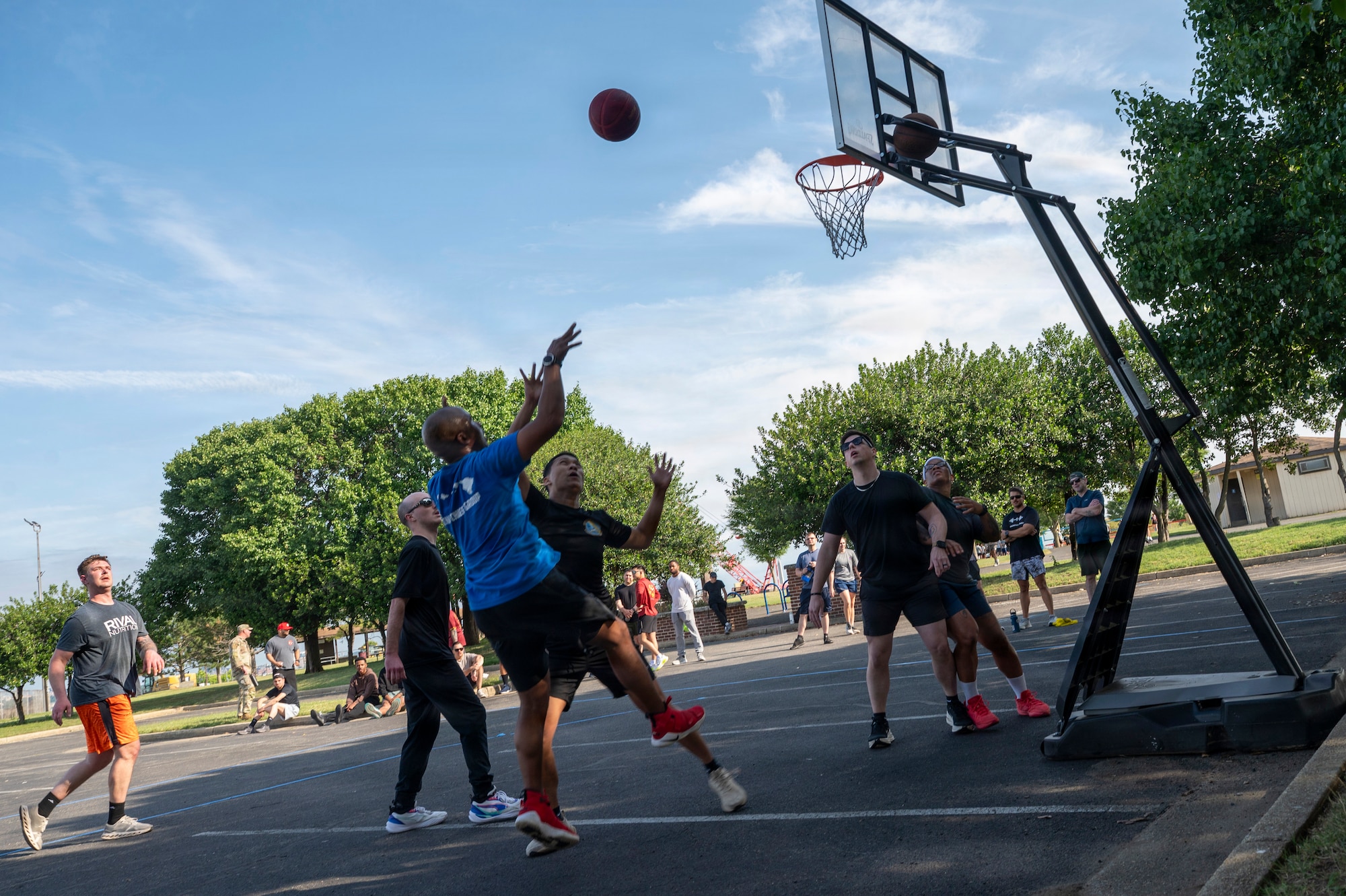 U.S. Air Force Chief Master Sgt. Anthony Thompson Jr., senior enlisted leader for Joint Base Anacostia-Bolling and the 11th Wing command chief, shoots a basketball during a 3v3 basketball match at JBAB, Washington, D.C., June 9, 2026. The annual sports day event, included a Humvee push, pickleball, tire flip, 3v3 basketball, wall climbing, tug-of-war and volleyball (U.S. Air Force photo by Hayden Hallman)