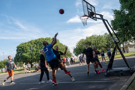 U.S. Air Force Chief Master Sgt. Anthony Thompson Jr., senior enlisted leader for Joint Base Anacostia-Bolling and the 11th Wing command chief, shoots a basketball during a 3v3 basketball match at JBAB, Washington, D.C., June 9, 2026. The annual sports day event, included a Humvee push, pickleball, tire flip, 3v3 basketball, wall climbing, tug-of-war and volleyball (U.S. Air Force photo by Hayden Hallman)