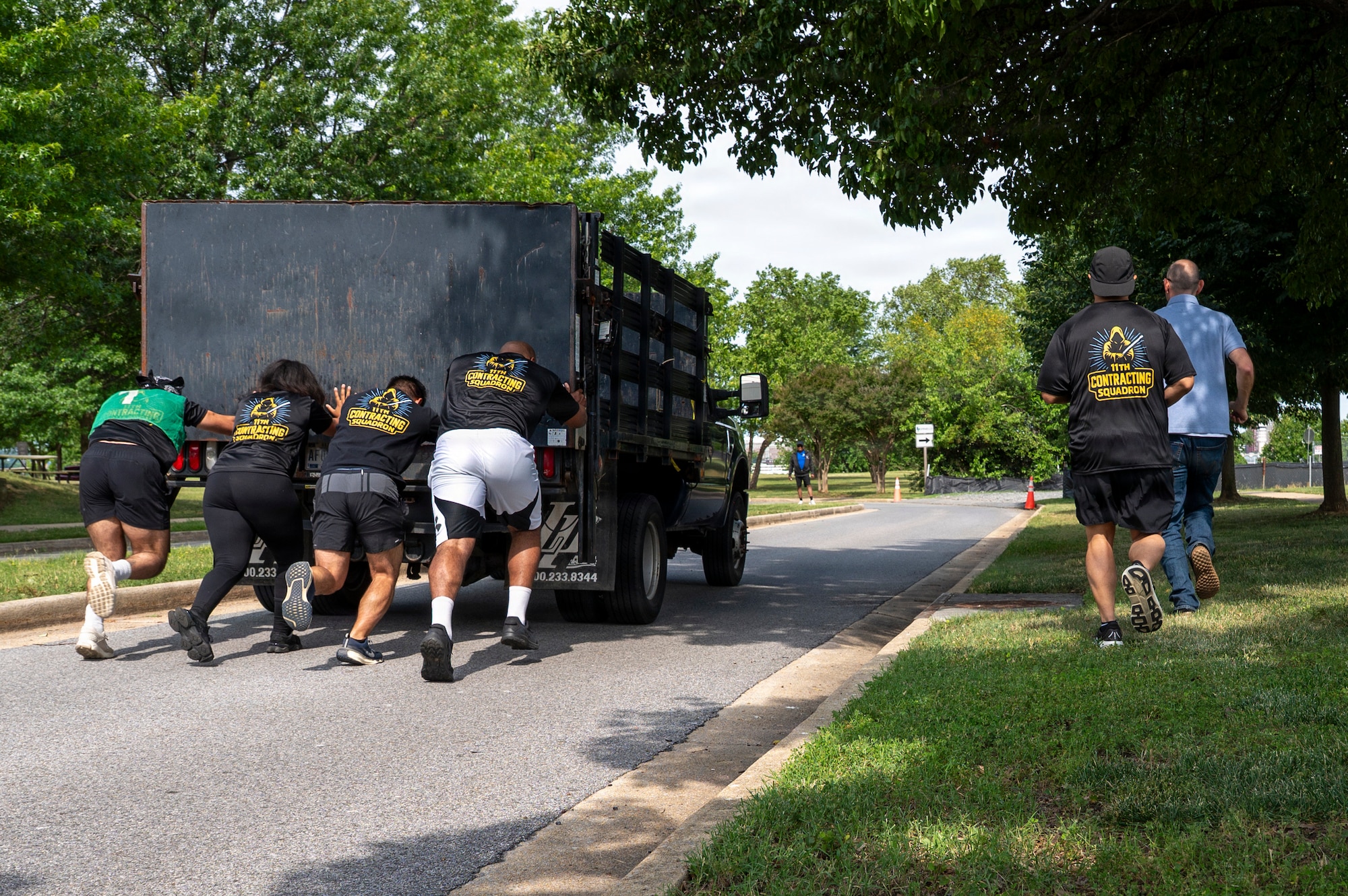 Members from the 11th Contracting Squadron push a truck during a base sports day at Joint Base Anacostia-Bolling, Washington, D.C., June 9, 2026. Service members participated in a variety of games and competitions to increase esprit de corps and unit camaraderie. (U.S. Air Force photo by Hayden Hallman)