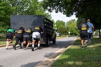Members from the 11th Contracting Squadron push a truck during a base sports day at Joint Base Anacostia-Bolling, Washington, D.C., June 9, 2026. Service members participated in a variety of games and competitions to increase esprit de corps and unit camaraderie. (U.S. Air Force photo by Hayden Hallman)