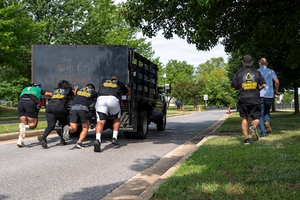Members from the 11th Contracting Squadron push a truck during a base sports day at Joint Base Anacostia-Bolling, Washington, D.C., June 9, 2026. Service members participated in a variety of games and competitions to increase esprit de corps and unit camaraderie. (U.S. Air Force photo by Hayden Hallman)