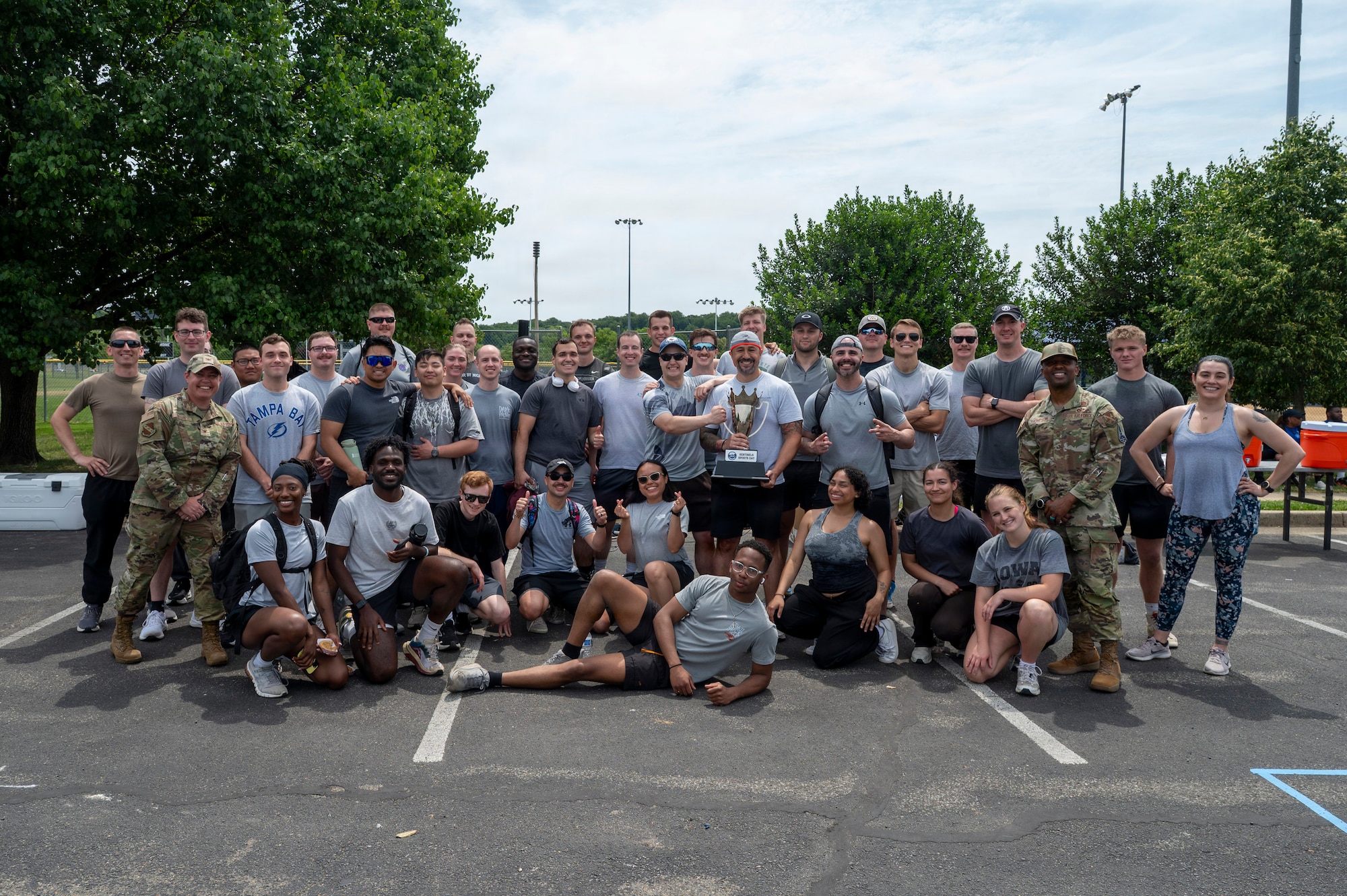 The 794th Communications Squadron gathers with Joint Base Anacostia-Bolling leadership after winning the base sports day trophy at JBAB, Washington, D.C., June 9, 2026. The annual event, which included a Humvee push, pickleball, tire flip, 3v3 basketball, wall climbing, tug-of-war and volleyball, fostered teamwork, camaraderie, physical fitness and friendly competition. (U.S. Air Force photo by Hayden Hallman)