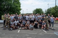 The 794th Communications Squadron gathers with Joint Base Anacostia-Bolling leadership after winning the base sports day trophy at JBAB, Washington, D.C., June 9, 2026. The annual event, which included a Humvee push, pickleball, tire flip, 3v3 basketball, wall climbing, tug-of-war and volleyball, fostered teamwork, camaraderie, physical fitness and friendly competition. (U.S. Air Force photo by Hayden Hallman)