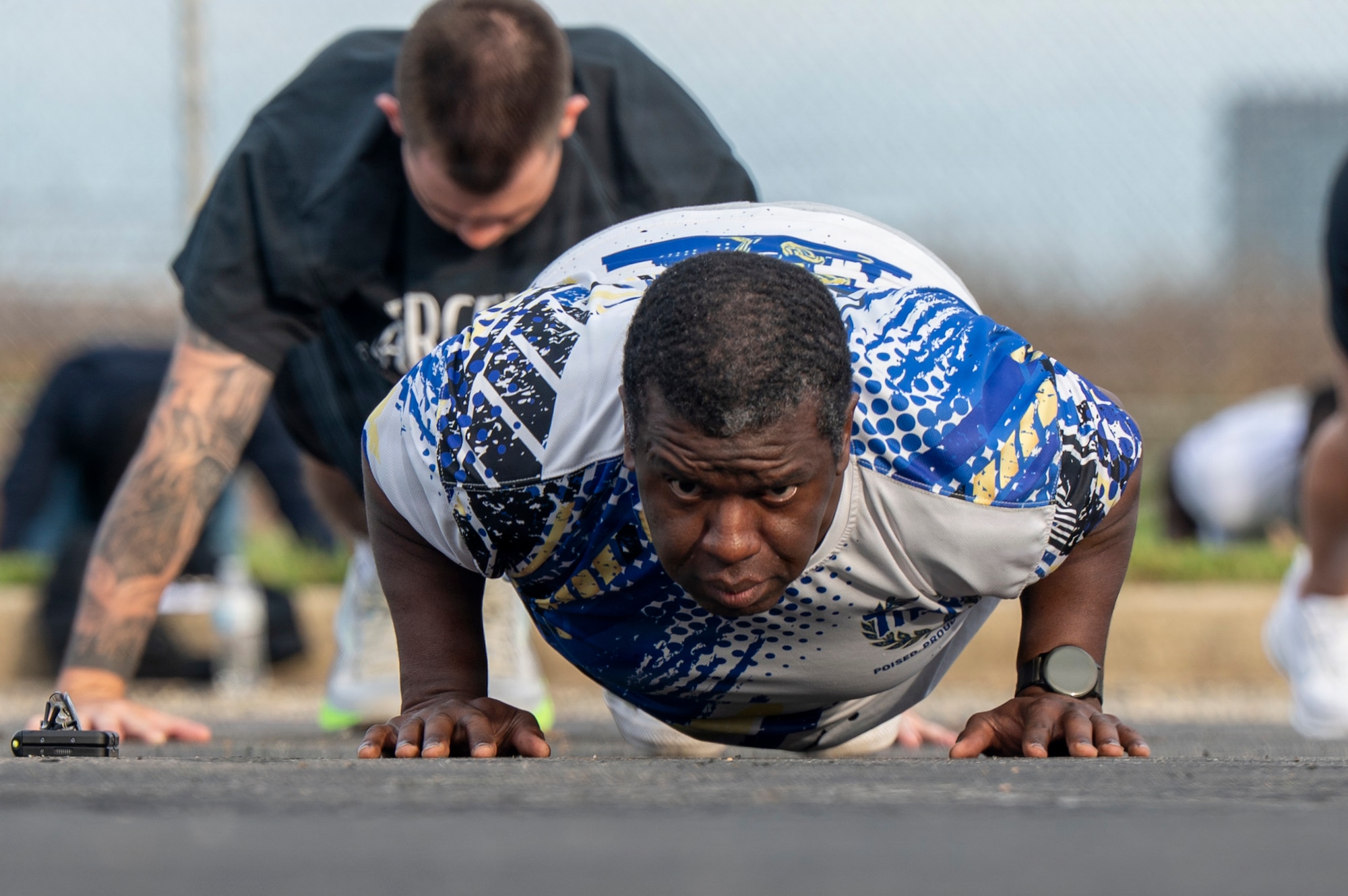 U.S. Air Force Tech. Sgt. George Stoudemire, personnel systems manager with the 11th Flight Support Squadron, conducts push-ups during a base sports day at Joint Base Anacostia-Bolling, Washington, D.C., June 9, 2026. The sports day started with a fitness bootcamp which is a class offered by the JBAB Aerobic Center. (U.S. Air Force photo by Hayden Hallman)