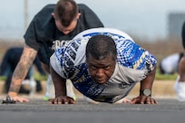 U.S. Air Force Tech. Sgt. George Stoudemire, personnel systems manager with the 11th Flight Support Squadron, conducts push-ups during a base sports day at Joint Base Anacostia-Bolling, Washington, D.C., June 9, 2026. The sports day started with a fitness bootcamp which is a class offered by the JBAB Aerobic Center. (U.S. Air Force photo by Hayden Hallman)