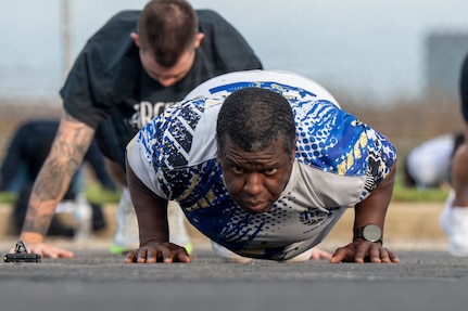 U.S. Air Force Tech. Sgt. George Stoudemire, personnel systems manager with the 11th Flight Support Squadron, conducts push-ups during a base sports day at Joint Base Anacostia-Bolling, Washington, D.C., June 9, 2026. The sports day started with a fitness bootcamp which is a class offered by the JBAB Aerobic Center. (U.S. Air Force photo by Hayden Hallman)