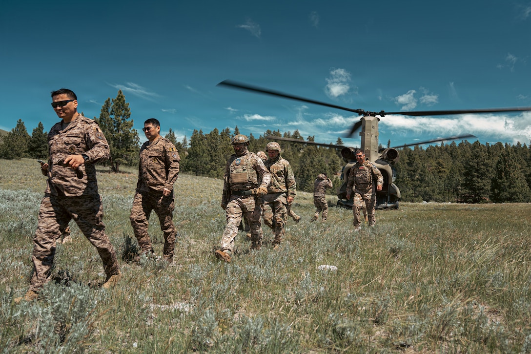 Armenian, Kyrgyz Republic, and Mongolian partners as well as Utah National Guard Sgt. Patrick Hansen, 300th Military Intelligence Brigade, disembark from a U.S. National Guard Boeing CH-47 Chinook as part of CH-47 familiarization during Exercise Regional Cooperation 26 at Fort Harrison, Montana, June 10, 2026. Regional Cooperation 26 is an annual, multi-national U.S. Central Command sponsored command-post, field training exercise and cyber defense training conducted by U.S. National Guard units in partnership with Central and South Asia nations. (Oklahoma National Guard photo by Sgt. Anthony Ackah-Mensah)