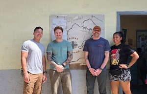 Air National Guardsmen take a photo with locals while volunteering at a orphanage during their deployment in Djibouti, Feb. 21. Members of the 130th Airlift Wing set up a medical clinic to assist with wound care for the local populace.