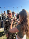 U.S. Army Pvt. 1st Class Mace Veit, 1st Battalion, 221st Cavalry, Nevada National Guard, is being pinned his airborne pin by his sister at Fort Benning, Georgia, April 17, 2026. Veit completed Ranger School, Airborne School, Air Assault School and Pathfinder School before his 20th birthday, accomplishing in less than six months what can take many Soldiers years to achieve. Courtesy photo.