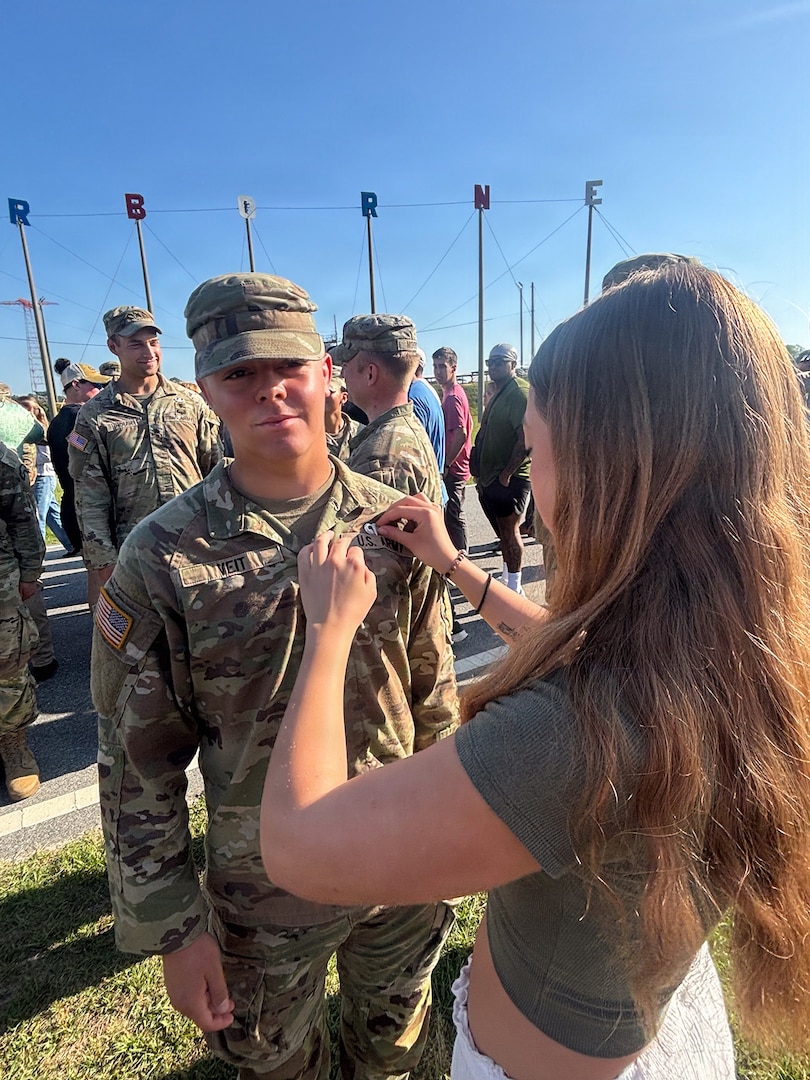 U.S. Army Pvt. 1st Class Mace Veit, 1st Battalion, 221st Cavalry, Nevada National Guard, is being pinned his airborne pin by his sister at Fort Benning, Georgia, April 17, 2026.