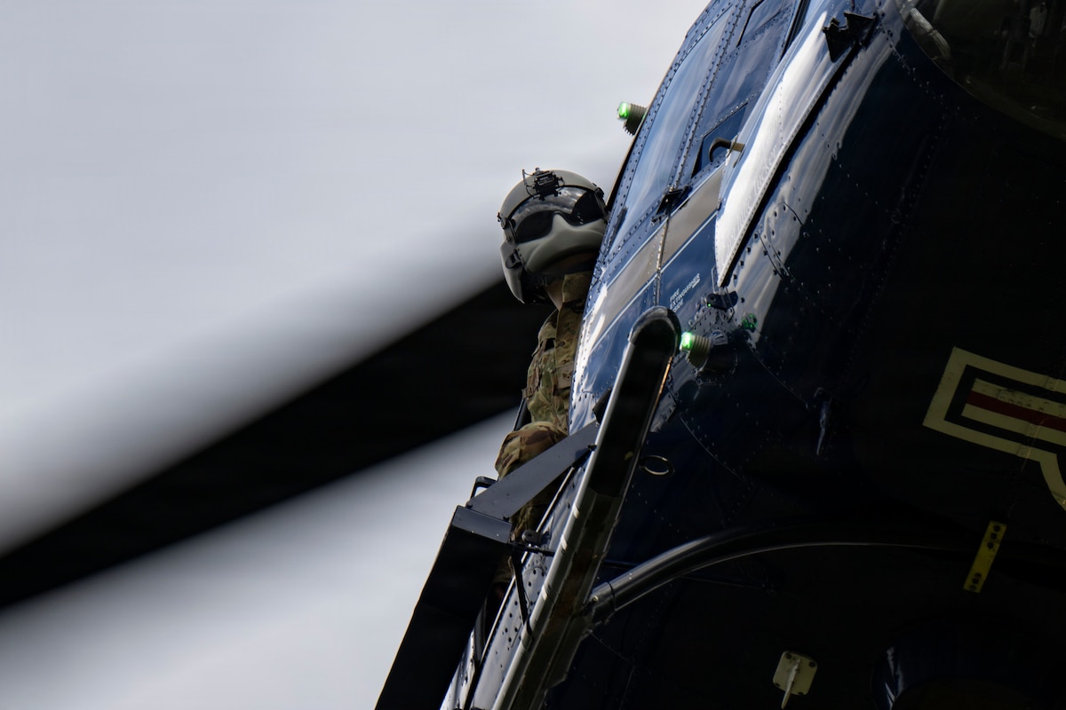 Senior Airman Hayden Tadgerson, 1st Helicopter Squadron UH-1N Huey flight engineer, checks the surrounding area after takeoff at Joint Base Andrews, Md., May 27, 2026. The helicopter crew simulated a medical evacuation flight following a Tactical Combat Casualty Care exercise. (U.S. Air Force photo by Staff Sgt. Julia Lebens)