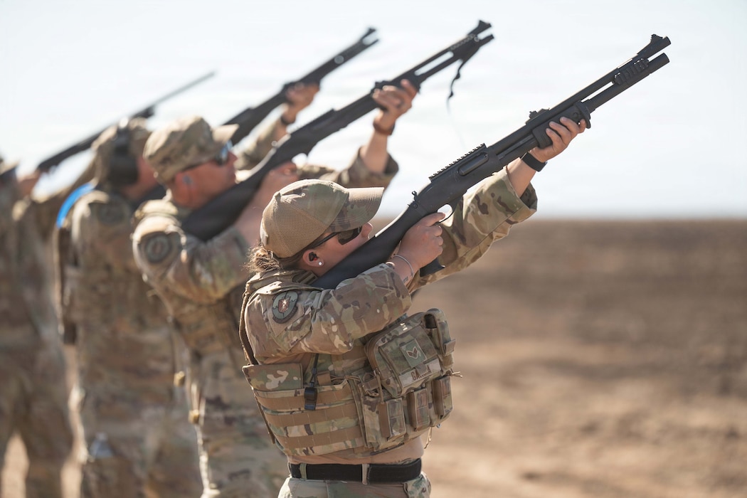 Airmen assigned to the 124th Security Forces Squadron, Idaho Air National Guard, participate in counter-drone training. They points their weapon in the sky to take down drone.